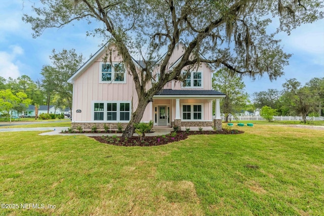 85199 Southern Creek Blvd, Fernandina Beach, FL 32034 - view of front of property with board and batten siding, a front yard, and stone siding