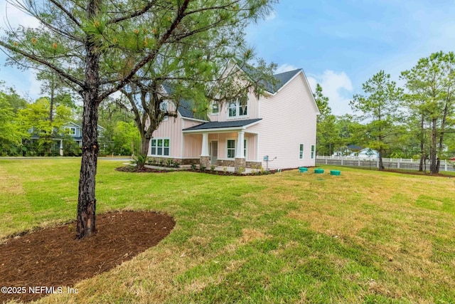 85199 Southern Creek Blvd, Fernandina Beach, FL 32034 - view of home's exterior featuring board and batten siding, a lawn, and fence