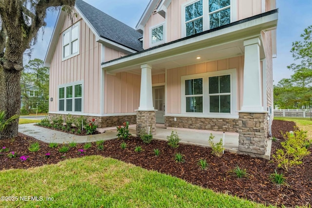 85199 Southern Creek Blvd, Fernandina Beach, FL 32034 - entrance to property with a shingled roof, board and batten siding, a porch, and stone siding