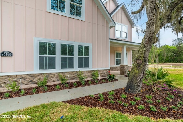 85199 Southern Creek Blvd, Fernandina Beach, FL 32034 - view of side of property with covered porch, board and batten siding, and stone siding