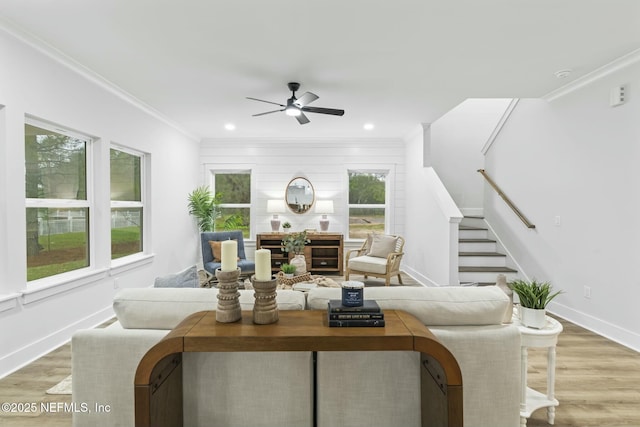 85199 Southern Creek Blvd, Fernandina Beach, FL 32034 - living room featuring crown molding, baseboards, ceiling fan, stairway, and light wood finished floors