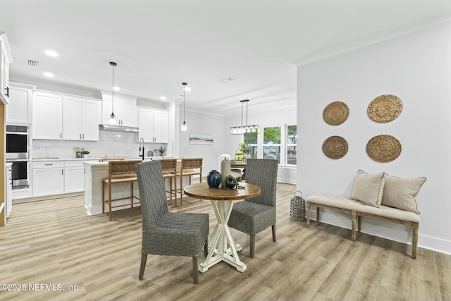 85199 Southern Creek Blvd, Fernandina Beach, FL 32034 - dining space with crown molding, recessed lighting, light wood finished floors, and baseboards