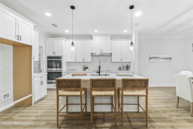 85199 Southern Creek Blvd, Fernandina Beach, FL 32034 - kitchen with stainless steel double oven, visible vents, light countertops, baseboards, and ornamental molding