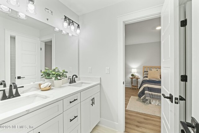 85199 Southern Creek Blvd, Fernandina Beach, FL 32034 - bathroom featuring baseboards, ensuite bath, a sink, and wood finished floors
