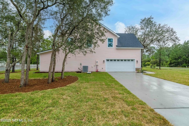 85199 Southern Creek Blvd, Fernandina Beach, FL 32034 - view of property exterior with concrete driveway, a lawn, central AC, and a garage