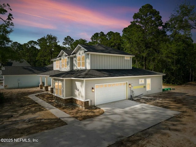 85084 Southern Creek Blvd, Fernandina Beach, FL 32034 - view of front of home featuring a garage, board and batten siding, stone siding, and concrete driveway