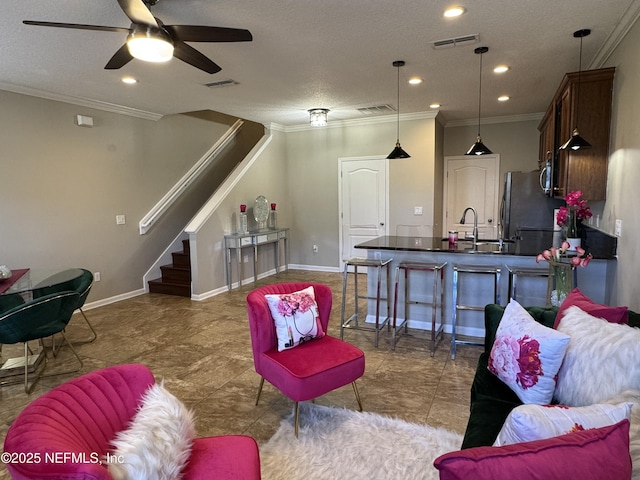 528 Sherwood Oaks Dr, Orange Park, FL 32073 - living area with visible vents, crown molding, baseboards, stairs, and a ceiling fan