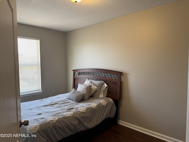 528 Sherwood Oaks Dr, Orange Park, FL 32073 - bedroom with baseboards, a textured ceiling, and dark wood finished floors