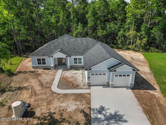 85118 Southern Creek Blvd, Fernandina Beach, FL 32034 - single story home featuring roof with shingles, an attached garage, driveway, and stone siding