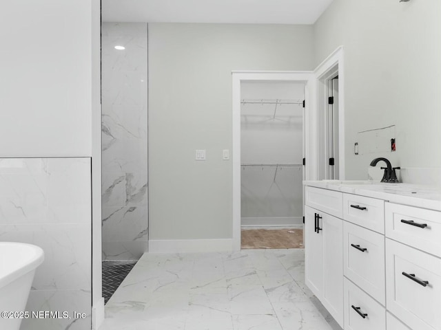 85118 Southern Creek Blvd, Fernandina Beach, FL 32034 - full bath with vanity, marble finish floor, a walk in closet, a soaking tub, and a marble finish shower