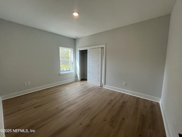85118 Southern Creek Blvd, Fernandina Beach, FL 32034 - unfurnished bedroom with baseboards, a closet, and dark wood-style floors