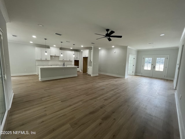 85118 Southern Creek Blvd, Fernandina Beach, FL 32034 - unfurnished living room featuring crown molding, a ceiling fan, baseboards, recessed lighting, and dark wood-type flooring