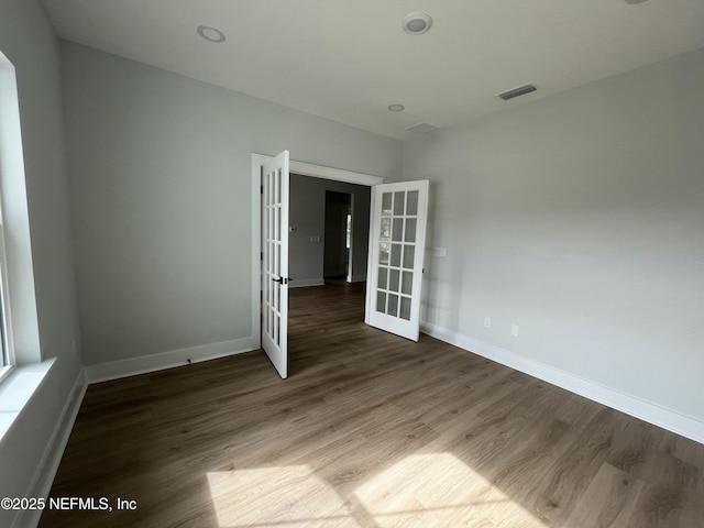 85118 Southern Creek Blvd, Fernandina Beach, FL 32034 - empty room with baseboards, visible vents, french doors, and wood finished floors