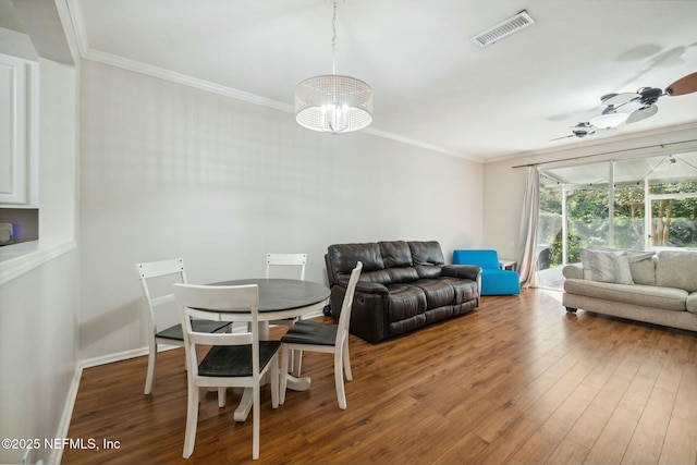 7990 Baymeadows Rd E Unit 2202, Jacksonville, FL 32256 - dining area featuring crown molding, wood finished floors, a ceiling fan, baseboards, and a chandelier
