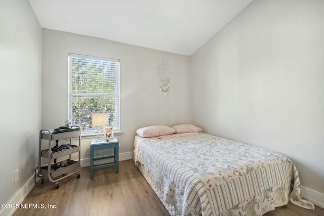 7990 Baymeadows Rd E Unit 2202, Jacksonville, FL 32256 - bedroom featuring wood finished floors, baseboards, and vaulted ceiling