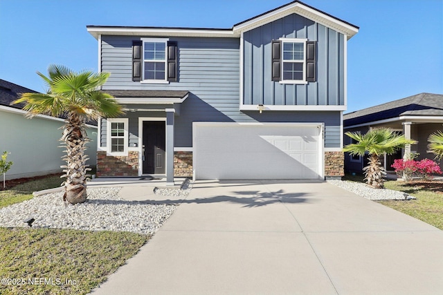 view of front of home with stone siding, board and batten siding, concrete driveway, and an attached garage