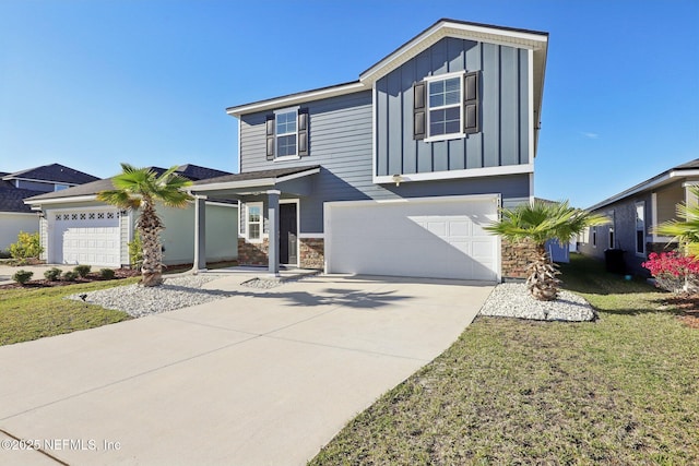 view of front of house with a front lawn, stone siding, board and batten siding, concrete driveway, and a garage
