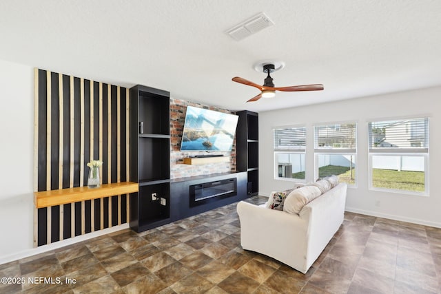 living area with visible vents, a fireplace, baseboards, and ceiling fan