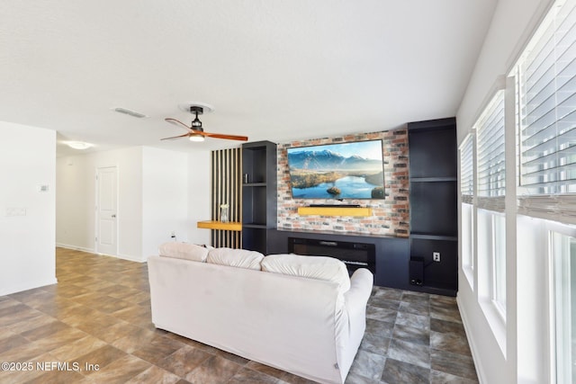 living room featuring visible vents and ceiling fan