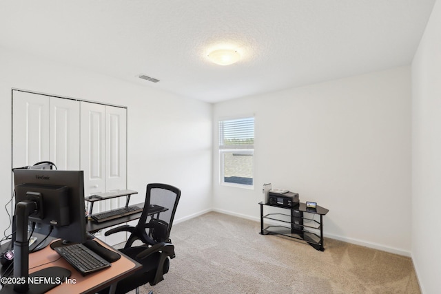 office area featuring visible vents, baseboards, and carpet floors