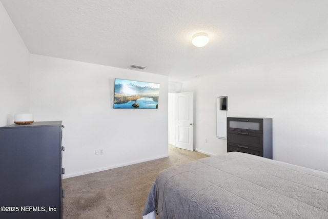 carpeted bedroom with visible vents and baseboards
