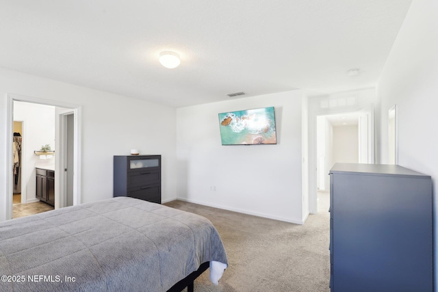 bedroom featuring visible vents, light carpet, and baseboards