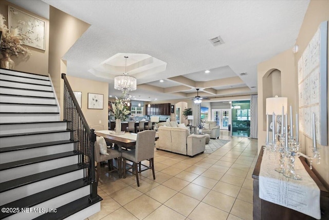 1074 Spanish Bay Ct, Orange Park, FL 32065 - dining area with visible vents, stairs, a raised ceiling, ceiling fan with notable chandelier, and light tile patterned floors