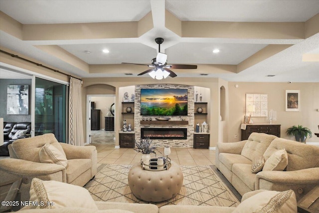 1074 Spanish Bay Ct, Orange Park, FL 32065 - living area with a raised ceiling, light tile patterned flooring, arched walkways, ceiling fan, and a fireplace