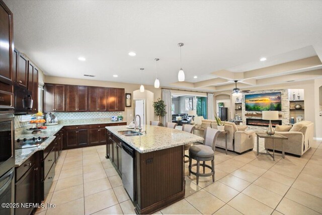 1074 Spanish Bay Ct, Orange Park, FL 32065 - kitchen with ceiling fan, a sink, black microwave, a breakfast bar area, and stainless steel dishwasher