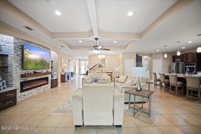 1074 Spanish Bay Ct, Orange Park, FL 32065 - living area with light tile patterned flooring, beamed ceiling, recessed lighting, and a glass covered fireplace