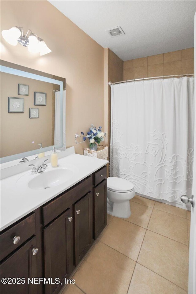 1074 Spanish Bay Ct, Orange Park, FL 32065 - full bathroom featuring visible vents, toilet, tile patterned floors, curtained shower, and vanity