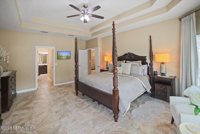 1074 Spanish Bay Ct, Orange Park, FL 32065 - bedroom with baseboards, a tray ceiling, visible vents, and a ceiling fan