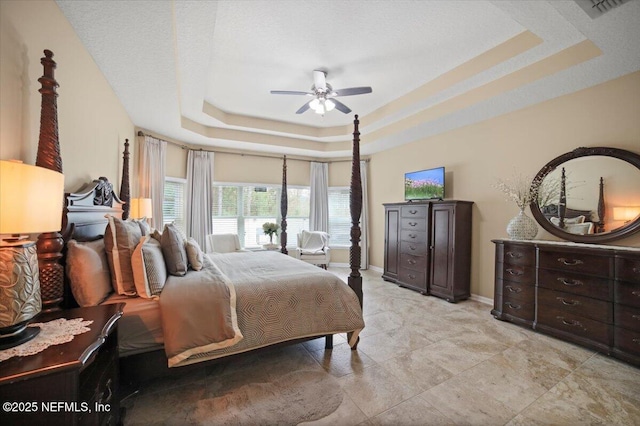 1074 Spanish Bay Ct, Orange Park, FL 32065 - bedroom featuring a tray ceiling, baseboards, and ceiling fan