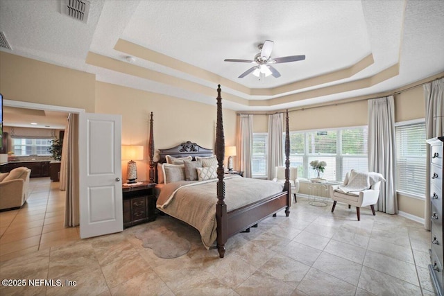 1074 Spanish Bay Ct, Orange Park, FL 32065 - bedroom featuring a textured ceiling, visible vents, baseboards, and a raised ceiling