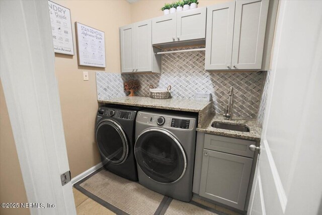 1074 Spanish Bay Ct, Orange Park, FL 32065 - laundry room featuring a sink, separate washer and dryer, tile patterned flooring, baseboards, and cabinet space