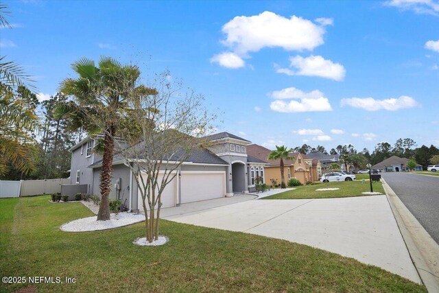 1074 Spanish Bay Ct, Orange Park, FL 32065 - view of front of home with a front lawn, fence, a garage, and concrete driveway