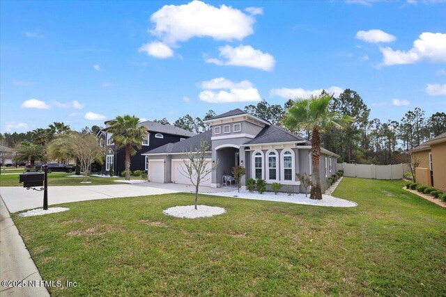 1074 Spanish Bay Ct, Orange Park, FL 32065 - view of front facade with driveway, a front yard, stucco siding, fence, and an attached garage