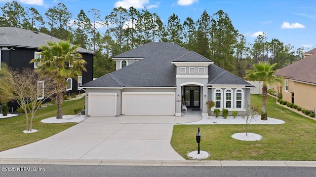 1074 Spanish Bay Ct, Orange Park, FL 32065 - french provincial home featuring a garage, concrete driveway, a front yard, stucco siding, and a shingled roof