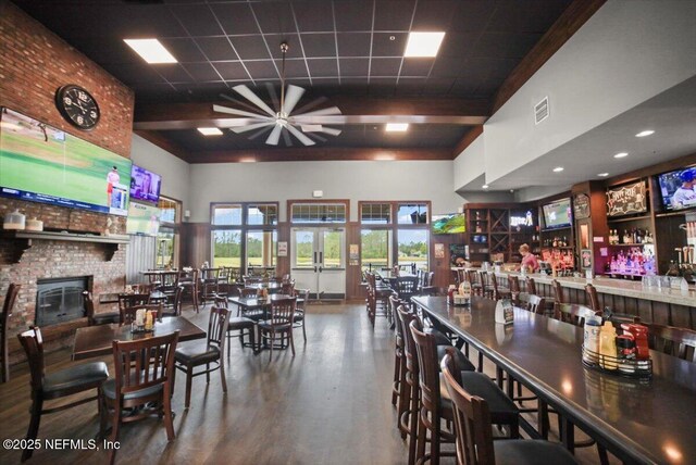 1074 Spanish Bay Ct, Orange Park, FL 32065 - dining area featuring a towering ceiling, visible vents, a community bar, ceiling fan, and wood finished floors