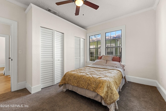 3824 Springfield Blvd, Jacksonville, FL 32206 - bedroom featuring visible vents, two closets, carpet flooring, crown molding, and baseboards