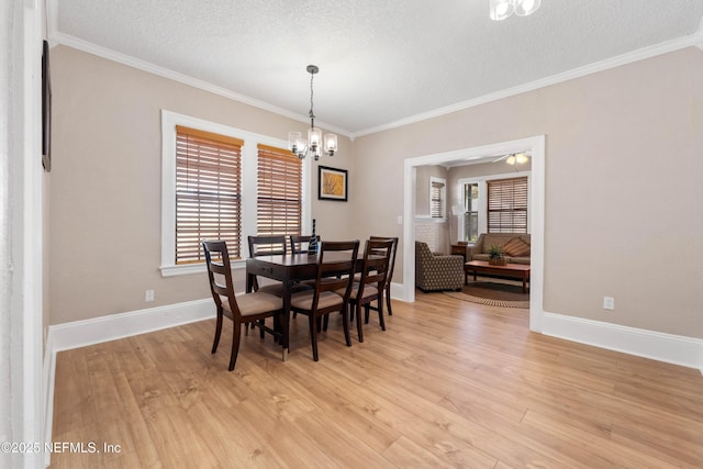 3824 Springfield Blvd, Jacksonville, FL 32206 - dining space featuring a textured ceiling, a notable chandelier, light wood-style flooring, and ornamental molding