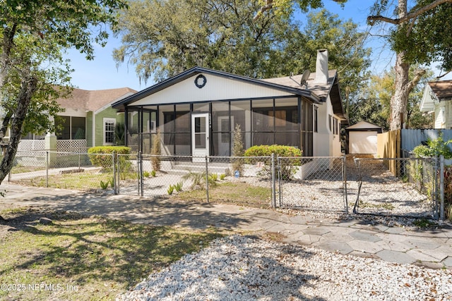 3824 Springfield Blvd, Jacksonville, FL 32206 - back of house featuring a gate, a chimney, fence private yard, and a sunroom