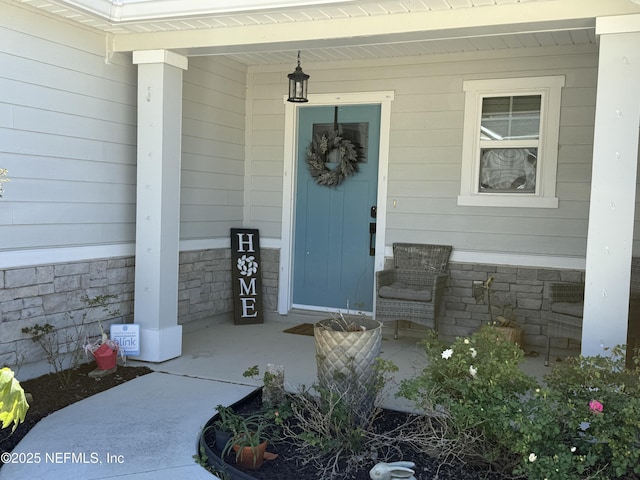665 Flach Dr, Saint Johns, FL 32259 - view of exterior entry featuring covered porch and stone siding