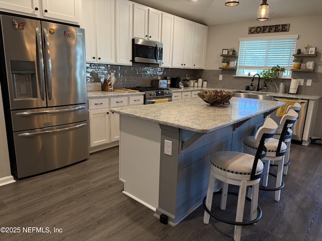 665 Flach Dr, Saint Johns, FL 32259 - kitchen with appliances with stainless steel finishes, open shelves, white cabinetry, and tasteful backsplash