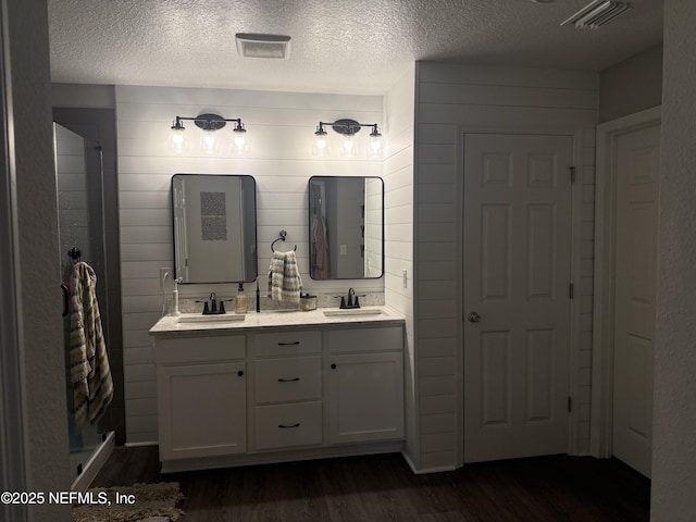 665 Flach Dr, Saint Johns, FL 32259 - full bathroom with wood finished floors, double vanity, and a textured ceiling