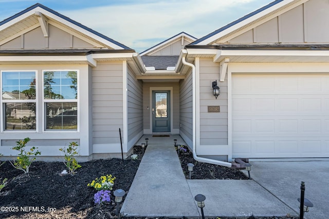 entrance to property featuring an attached garage