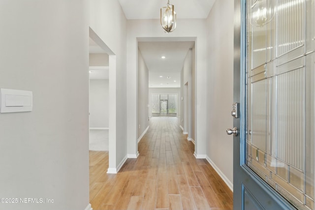 entryway with light wood-style floors and baseboards