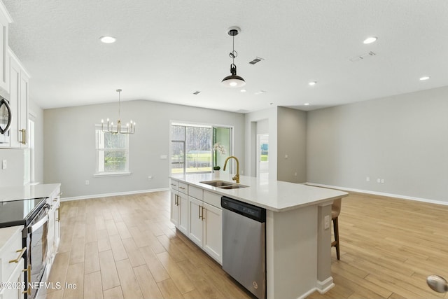 kitchen with visible vents, light wood-style flooring, a sink, stainless steel appliances, and white cabinets