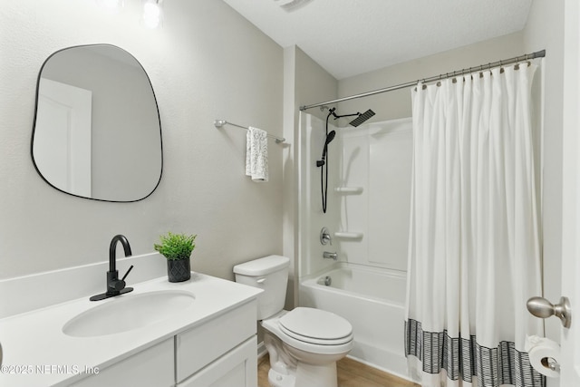 bathroom featuring shower / bath combo with shower curtain, toilet, vanity, wood finished floors, and a textured ceiling