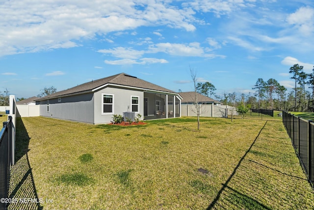 view of yard featuring central AC, a fenced backyard, and a sunroom